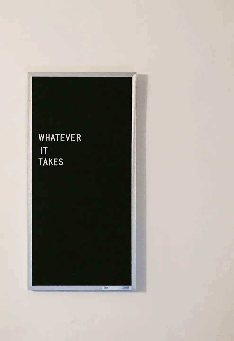 gray metal framed chalkboard with whatever it takes written